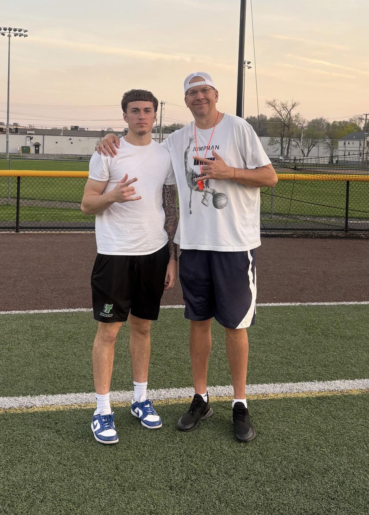 Coach Craig with a quarterback on the field