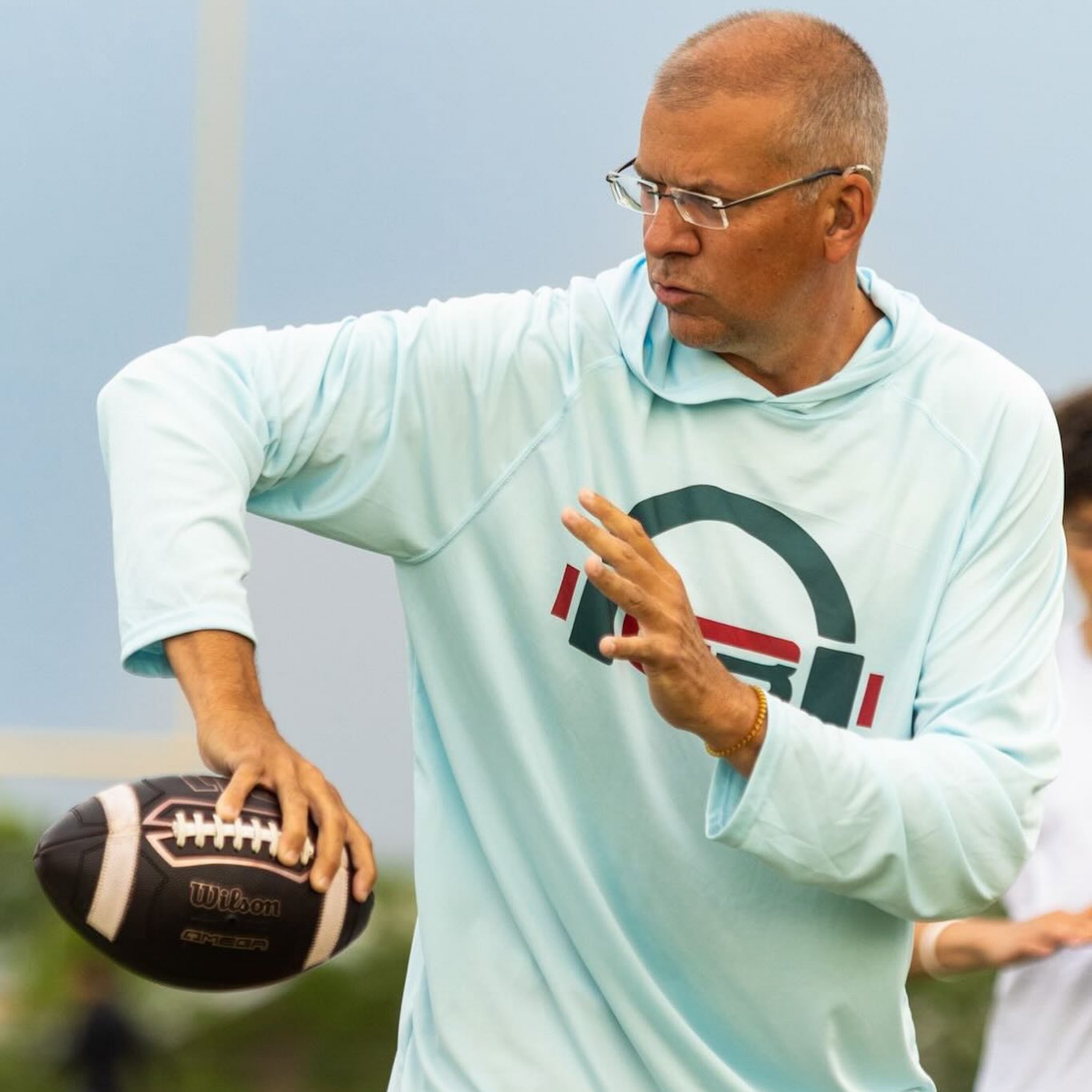 Craig demonstrating football grip and throwing technique