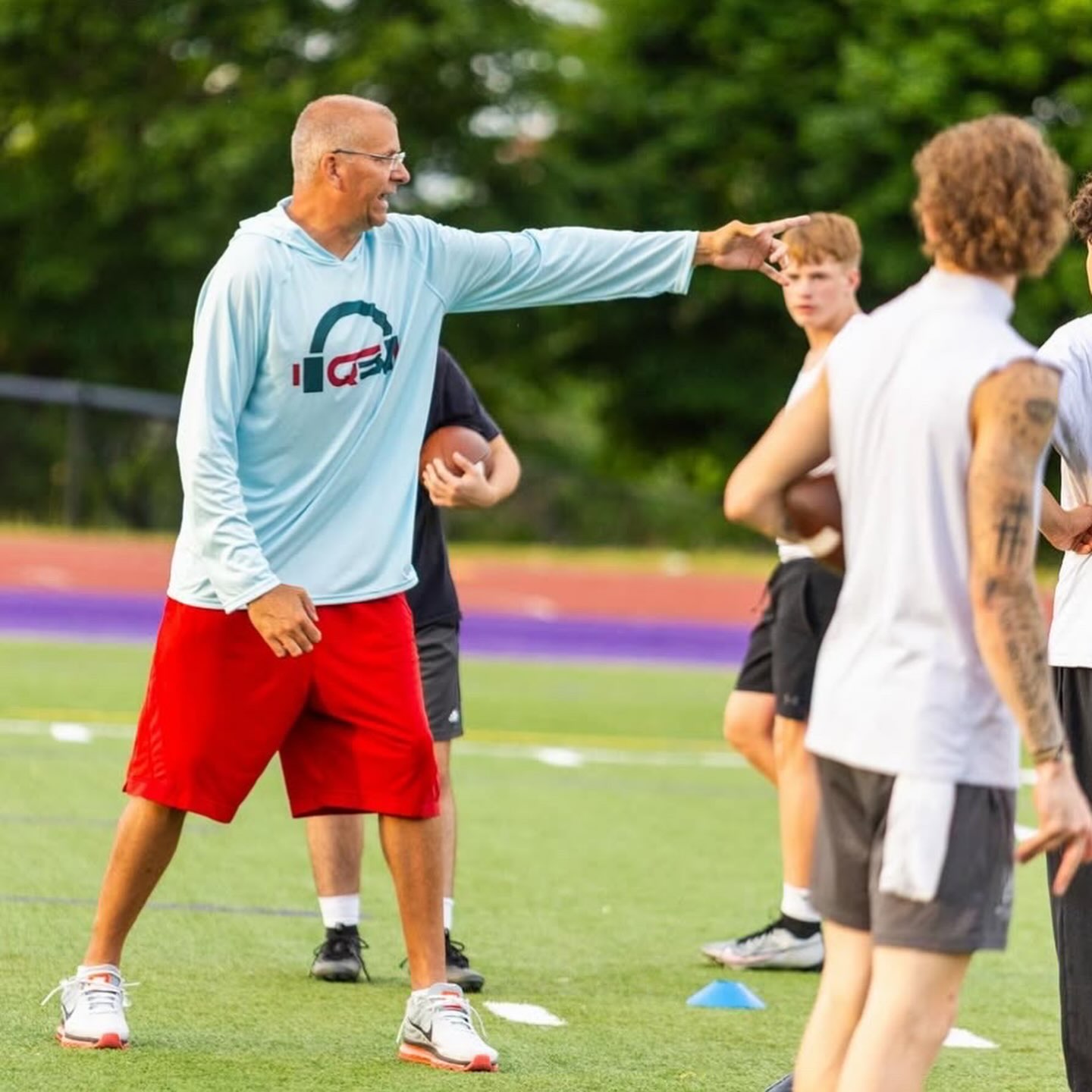 Craig directing quarterbacks during stance training